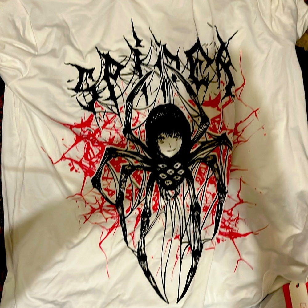 A white and black shirt with a spider girl